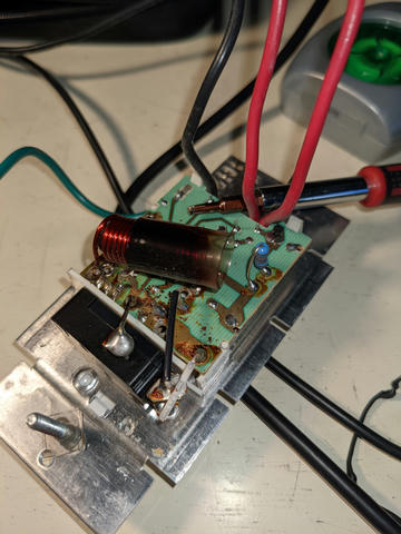 Opening up the dimmer switch reveals burnt flux, a large overheating inductor which may have radiated RF, and various other active components.
